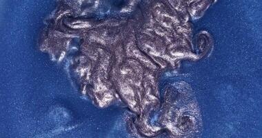 A close up of a blue liquid on a surface photo