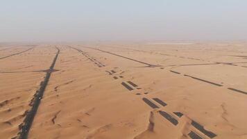 aerial view of a desert with a road in the middle photo