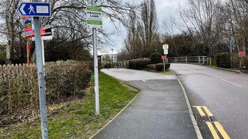 London, UK - March 02, 2025- Pathway on private land with signs on a cloudy day in Enfield, London photo