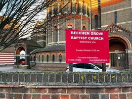 London, UK - March 02, 2025- Beechen Grove Baptist Church Sign With Brick Walls and Sunny Background photo