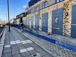 London, UK - March 02, 2025- Urban street view with pedestrian and modern brick building in the background photo