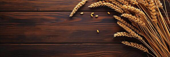 Wheat ears on a wooden table with copy space photo