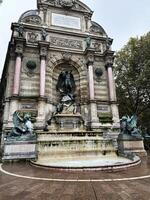 Paris, France - April 30, 2024 - Statue of Saint Michael and Archangel Featuring Fountain in Paris, France photo
