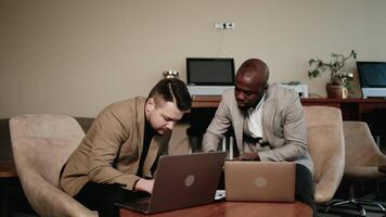 Group of happy people in business attire engaged in a conversation in their office. They are discussing and sharing ideas for their project, showing teamwork and cooperation video