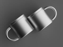 two metallic mugs touching at handles floating against grey background dramatic shadows photo
