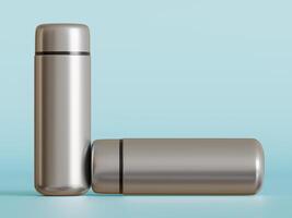 silver mini water bottles one upright one laying down light blue background soft shadows photo