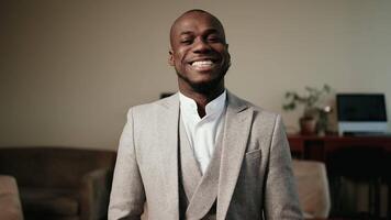 African American businessman smiling and looking at the camera in a modern office. The concept of confidence, success and professionalism in business video