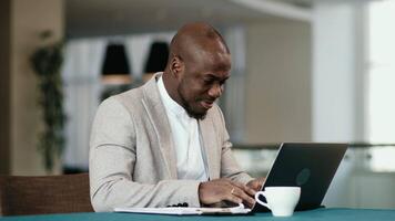 Thoughtful businessman think of online project looking at laptop at workplace, dreamy professional consider solution sit at work desk with computer, student search new idea inspiration in office cafe video
