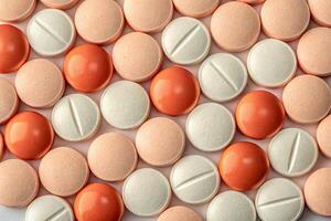 Collection of assorted colorful tablets and pills arranged in a pattern on a flat surface photo