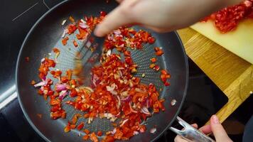 Cooking with aromatic herbs and spices, cooking vegetables for a rich taste, cooking onions and peppers, cooking a homemade dish step by step. Vegetarian cooking with fresh spices video