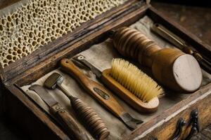 A wooden box with a variety of tools including a brush and a pair of scissors photo