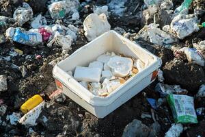 A trash can is full of garbage photo