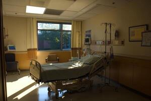 A hospital room with a bed and a window photo