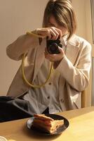 photographer, a woman with a professional camera takes a picture photo