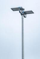 Led floodlights lighting up the sky on a metal pole photo
