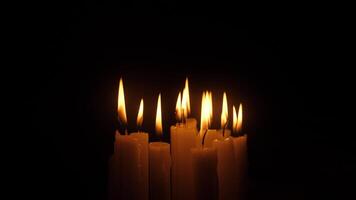 The beautifully lit candles are casting a warm and inviting glow against a dark, mysterious background video