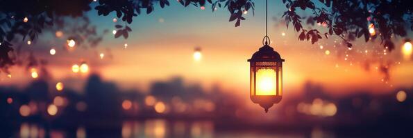 A lamp hanging from a tree in front of a city photo