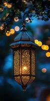 A lantern hanging from a tree with lights photo