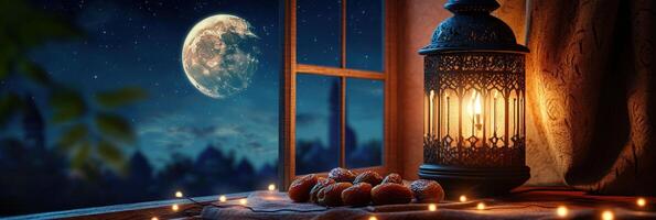 A lantern and a candle are on a window sill photo