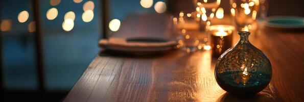 A candle is sitting on a table with a glass vase photo