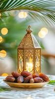 Ramadan lantern with dates and palm leaves on table photo