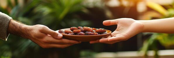 Two hands holding a bowl of dates photo