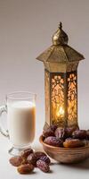 Dates and a cup of milk with a lantern on a table photo