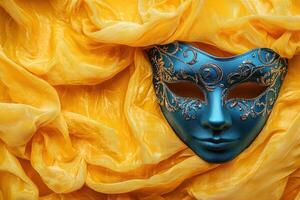 A blue and yellow venetian mask on a yellow background photo