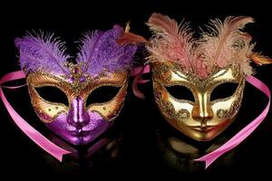 Two masquerade masks with feathers and ribbons photo