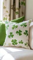 A pillow with shamrocks on it sits on a couch photo