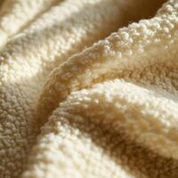 Soft and cozy boucle fabric close-up capturing warm textures photo