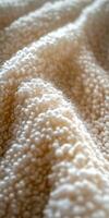 Close-up view of boucle fabric showcasing texture and softness photo