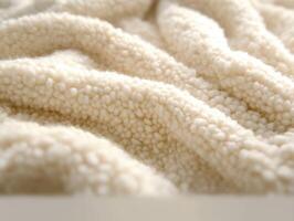 Soft and cozy boucle fabric in cream color texture close-up photo