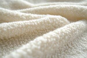 Soft white boucle fabric displaying textured folds and warmth photo
