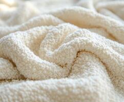 Textured boucle fabric in soft cream color on a cozy surface photo