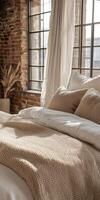 Cozy boucle bedding in a warm, sunny room with large windows photo