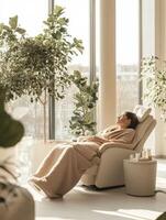 A woman in a robe is relaxing in a chair photo