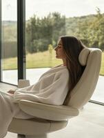 A woman in a robe sitting in a chair photo