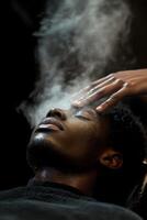 A man is getting his hair cut with steam coming out of his head photo