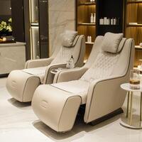 A massage chair and a table in a room photo