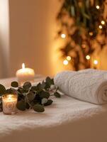 A massage table with candles and towels photo