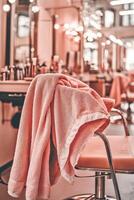 Microfiber towel draped on stylist chair in modern salon space photo