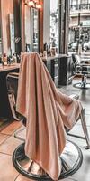 Soft microfiber towel draped over salon chair in bustling city shop photo