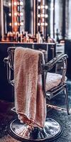 Microfiber towel draped over a stylish barber chair in a salon photo