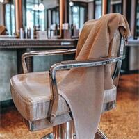 Microfiber towel draped over a salon chair in a modern salon setting photo