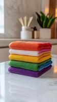 Colorful microfiber towels stacked neatly on a countertop photo