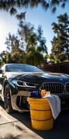 Microfiber towel rests on a bucket near a car in sunny setting photo