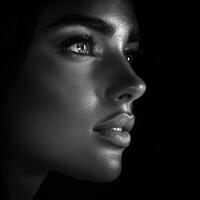 Portrait of a young woman in dramatic lighting and shadows photo