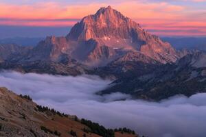 Majestic jagged mountain bathed in sunrise colors photo