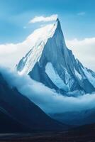 Jagged mountain peak surrounded by clouds at sunrise photo
